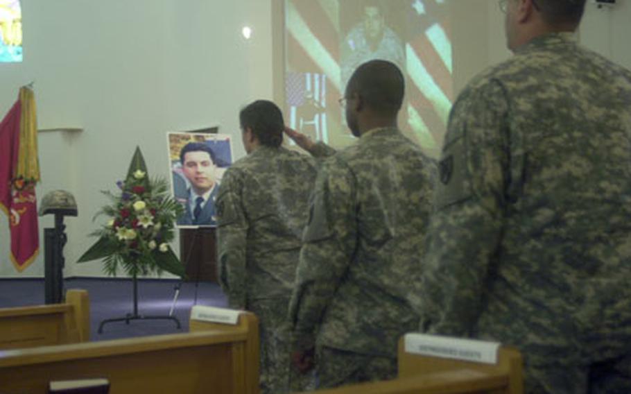 Soldiers with the 21st Theater Support Command salute the helmet, weapon and boots of Spc. Daniel Zizumbo on Tuesday afternoon at his memorial ceremony in Kaiserslautern, Germany. Zizumbo, 27, of the 1st Cargo Transfer Company, died as a result of a suicide bomb blast Feb. 27 at Bagram Air Base, Afghanistan.