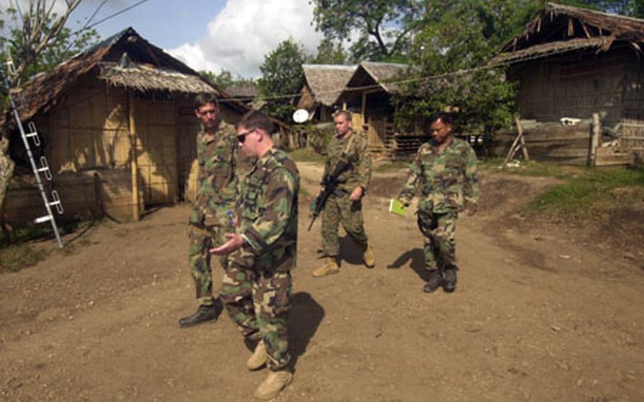 Civil Affairs Team 761&#39;s Sgt. 1st Class Woodrow Wilson III walks visitors through the “Seit Poblasion” Philippine marine base where they live on Jolo Island, Philippines. The camp sits near the center of the kidney-shaped island and on the edge of a volcanic crater lake.