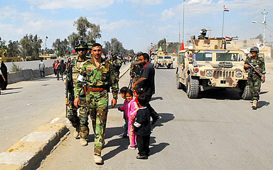 Iraqi army soldiers patrol the streets of Mahmudiyah recently during the Arba&#39;een pilgrimage.