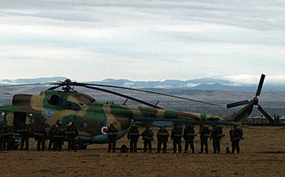 Georgian soldiers line up to board a Soviet-era Mi-8 helicopter for training at a nearby base. Since last summer, a contingent of U.S. soldiers, sailors and airmen have been in the small Caucasian country of Georgia trying to build an army brigade to NATO and Western standards.