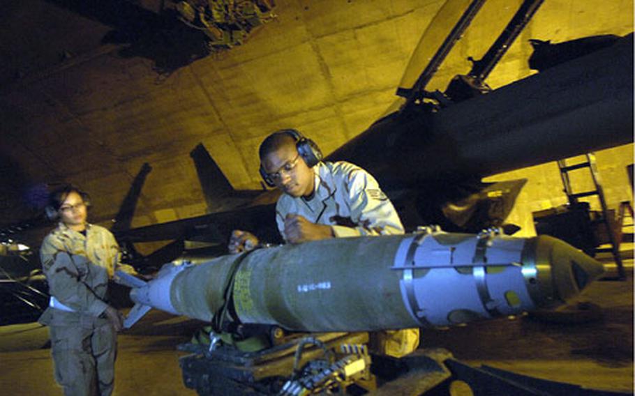Curry and Williams prepare to load munitions on this F-16 Fighting Falcon.