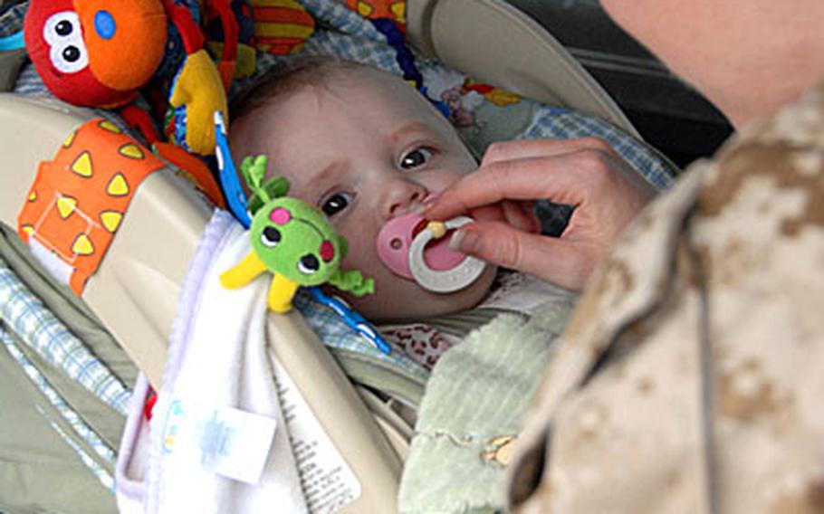 Capt. Sarah Spradlin puts her almost 7-month-old daughter, Alex, into the car Wednesday. Alex&#39;s Dad, Capt. Dev. Spradlin, a company commander with 9th Engineer Support Company, deployed a month before she was born.