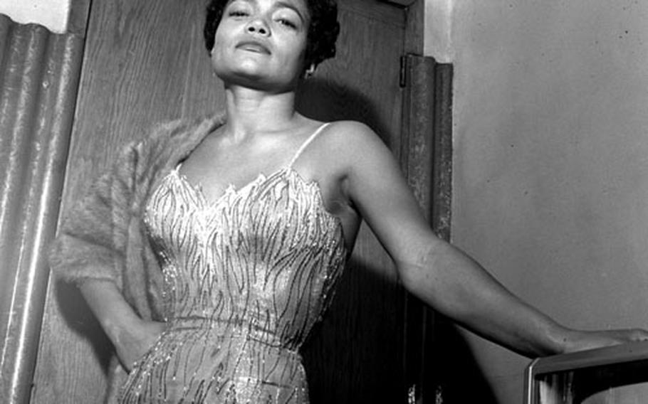 Eartha Kitt poses backstage in London in 1958.
