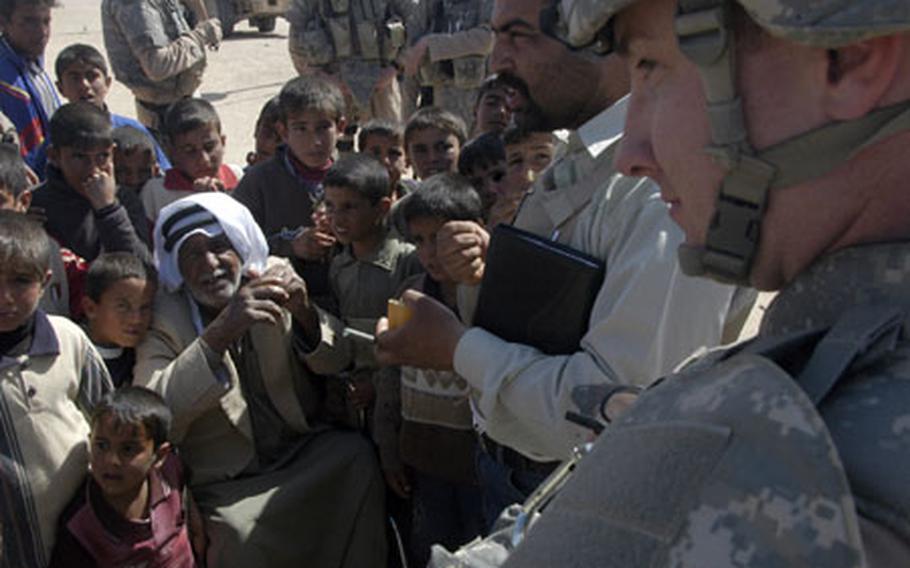 As Maj. Brian Melton, executive officer of 2nd Combined Arms Battalion, 136th Infantry Regiment of the Minnesota National Guard, listens via a translator, an elderly man tells the mayor of Habbaniyah that villagers won’t stop their work as fishermen to help the U.S. military improve their village.