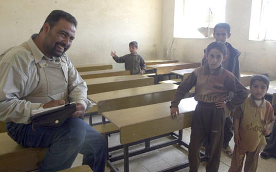 The mayor of Habbaniyah, Hussein Ali Hussein, takes notes during a visit Monday to an elementary school in the western Iraqi village of al Angur. The school has 400 pupils with only six classrooms. Children told Hussein they often sit four or five to each of the wooden bench desks.