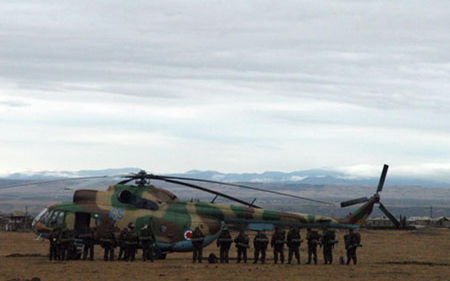 Georgian soldiers line up to board a Soviet-era Mi-8 helicopter for training at a nearby base.