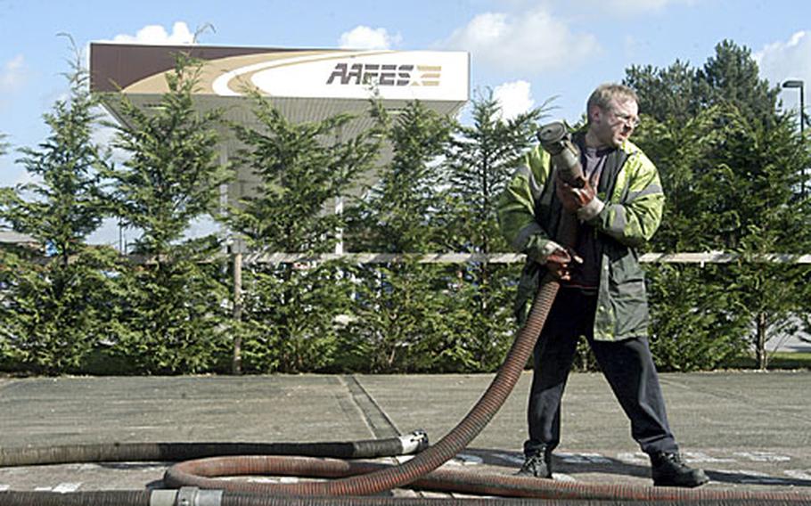 Cliff Kingham, from the Bob Terry Haulage Company, takes a hose back to his truck after pumping 32,500 liters of fuel from a storage tank at RAF Mildenhall&#39;s gas station last Thursday after tests showed that the fuel was contaminated.