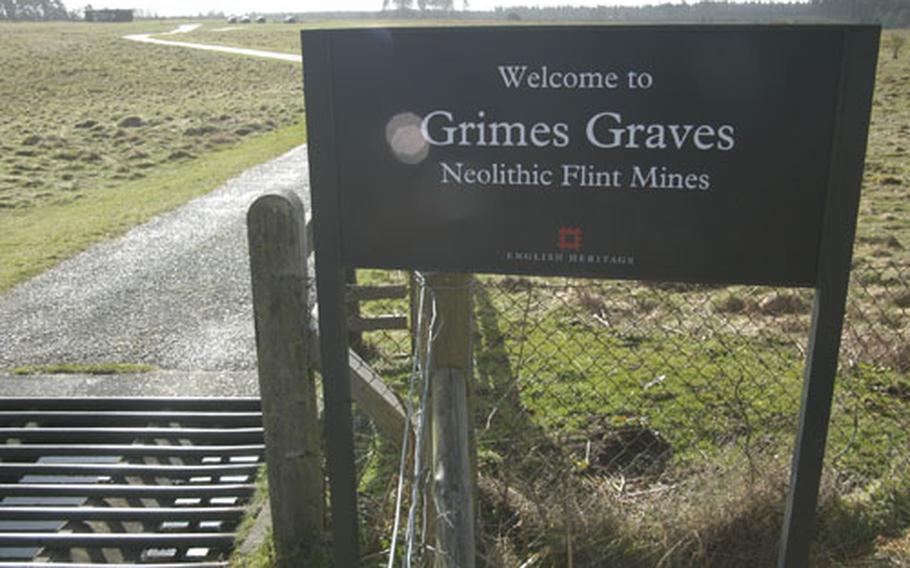 The entrance to Grimes Graves, near Thetford, lies along a one-lane country road.