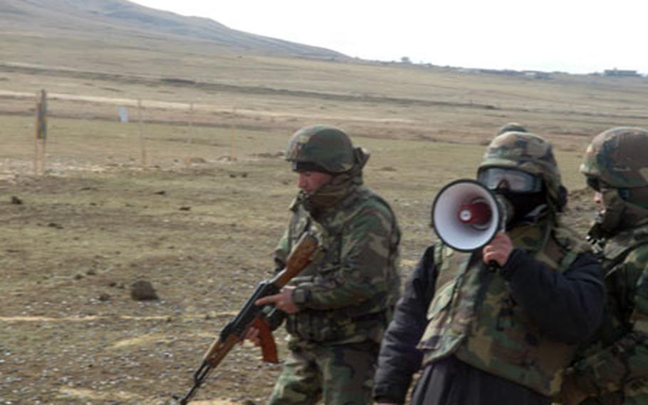 Some Georgian interpreters, like this one with the megaphone helping American instructors with marksmanship, have heard the trainers&#39; lessons so much in the past year that they say they can instruct the Georgian soldiers before the Americans are finished speaking.