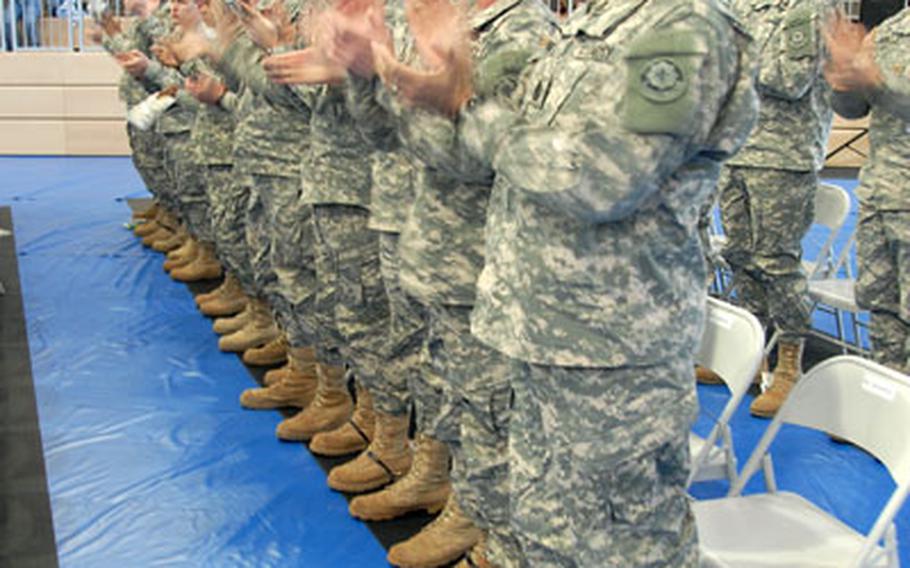 2nd Cavalry (Stryker) Regiment Command Sgt. Maj. Victor Martinez, foreground, and other 2nd Cav soldiers applaud 424 noncommissioned officers who graduated from the Warrior Leaders Course at Grafenwöhr, Germany, on Thursday.