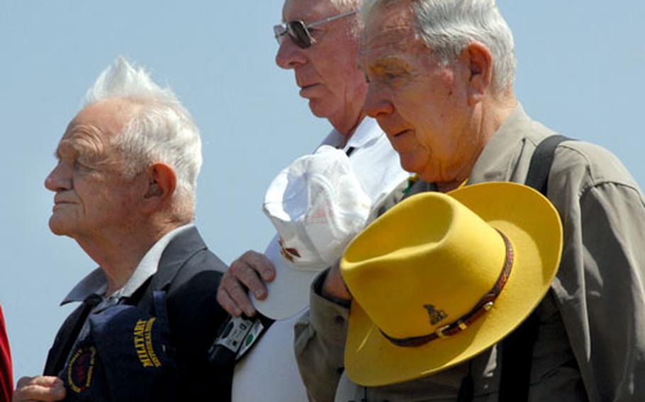 Hurb Thompson, center, and James Ware, right, stand with the other US veterans as a wreath is laid on the Reunion of Honor Memorial on Iwo Jima.