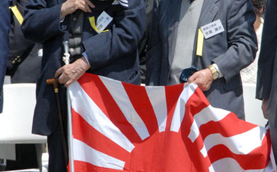 Japanese veterans of the battle for Iwo Jima stand as their national anthem plays during the ceremony on Wednesday.