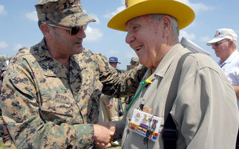 Lt. Gen. Joseph Weber shakes hands with WWII veteran James Ware after the ceremony on Wednesday.