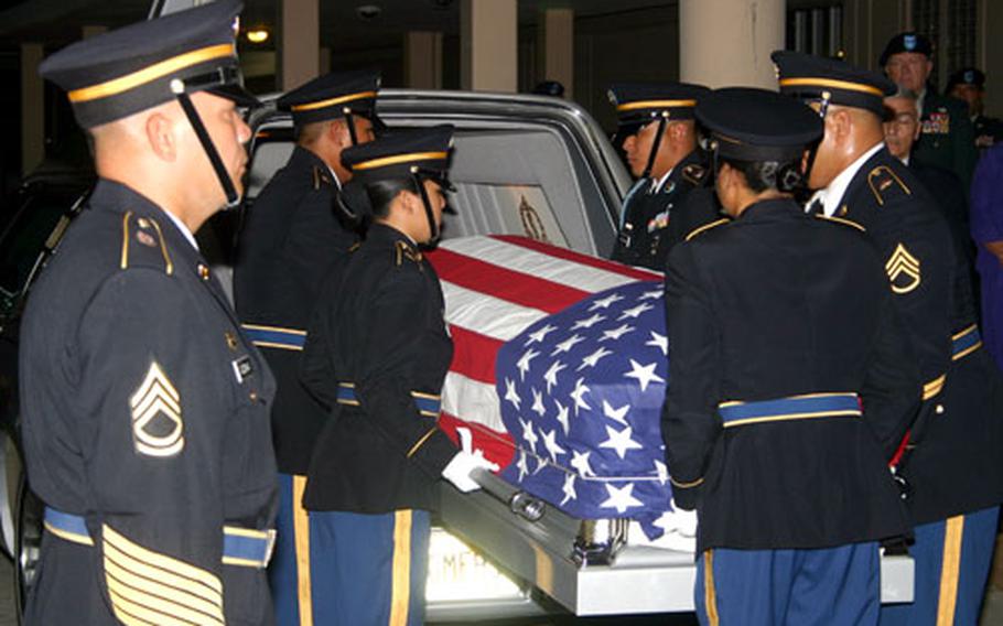 An honor guard removes the the casket containing the body of Guam Army National Guard member Sgt. Gregory Fejeran from the hearse during an early-morning welcoming ceremony at the A. B. Won Pat Guam International Airport on Saturday.