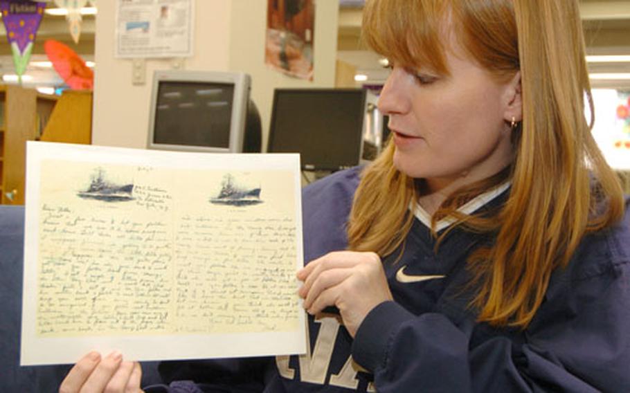 Kelly Sullivan Loughren reads a letter her grandfather had written during World War II.
