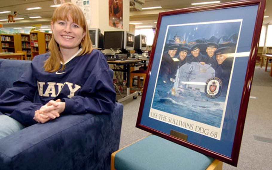 Kelly Sullivan Loughren, with a portrait of her grandfather and his brothers.