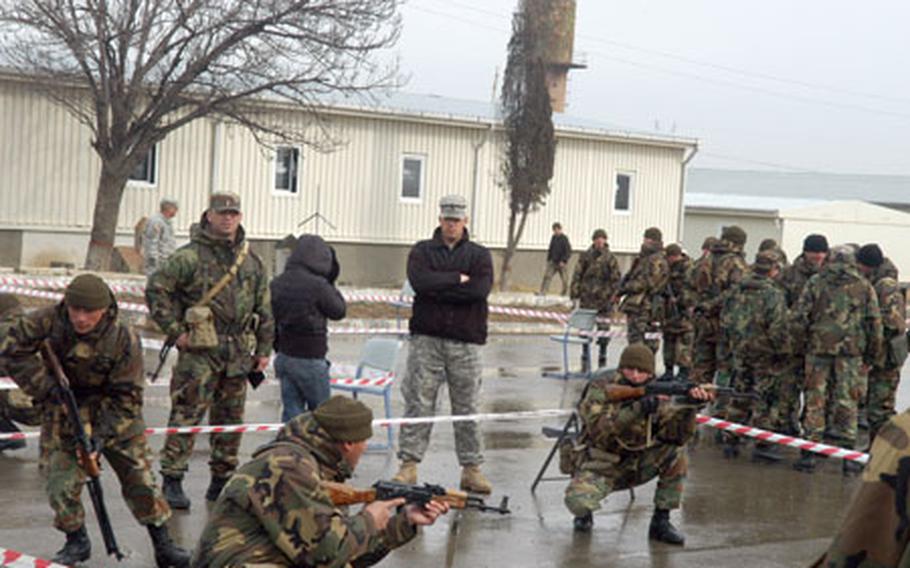 U.S. Army Sgt. Orlando Soto (with arms crossed) oversees Georgian soldiers conducting a room-clearing exercise.