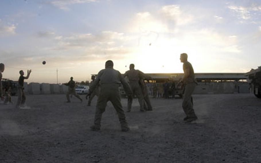 Marines with 4th Platoon, Transportation Detachment, Supply Company, 2nd Maintenance Battalion play an impromptu game of "ultimate football" at Camp Fallujah on Thursday evening after their return trip to Camp Taqaddum had been delayed several times. Security forces patrolling roadways between Fallujah and Taqaddum found several roadside bombs which first had to be defused.