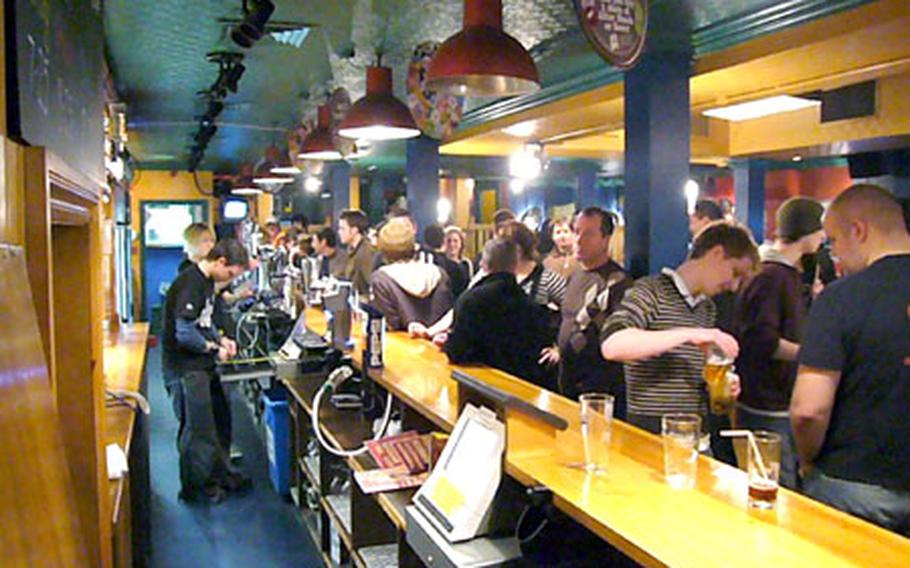 Customers line the bar at The Graduate pub in Cambridge on a recent quid night, when many beers are sold for a pound.