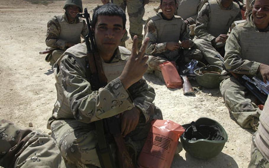 Moslim Hamoud, 22, flashes a peace sign during a lunch break Monday from range training during a 10-day School of Infantry course provided by U.S. Marines and Iraqi soldiers.