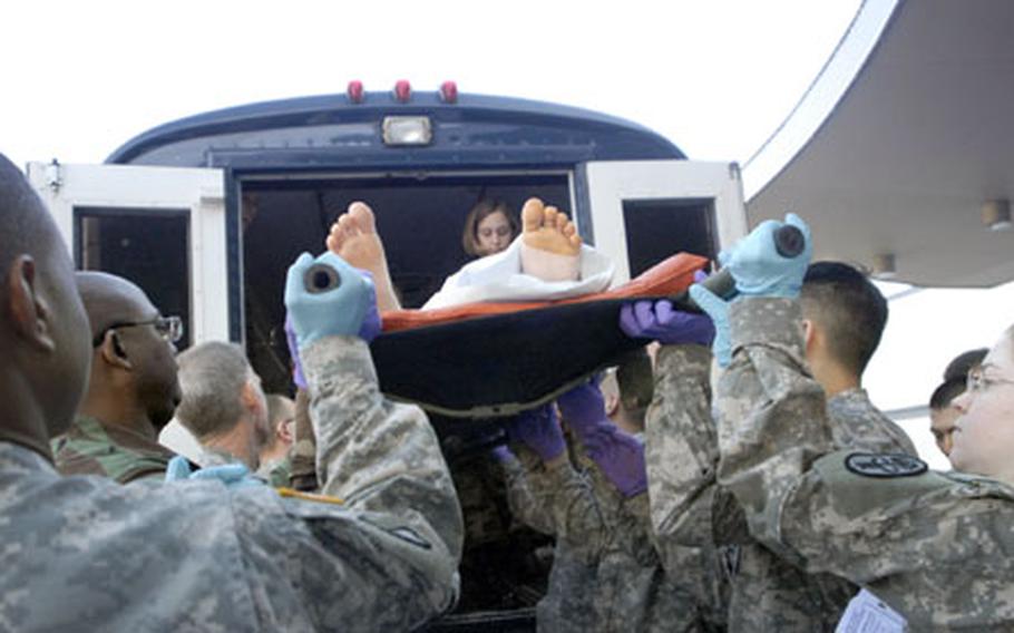 Army and Air Force volunteers help unload a bus carrying wounded just in from Iraq as it arrives at Landstuhl Regional Medical center on Nov. 16, 2006. Since May of last year, when Landstuhl began testing for traumatic brain injuries, the hospital has found that one in three of its war-related inpatients have some form of TBI.