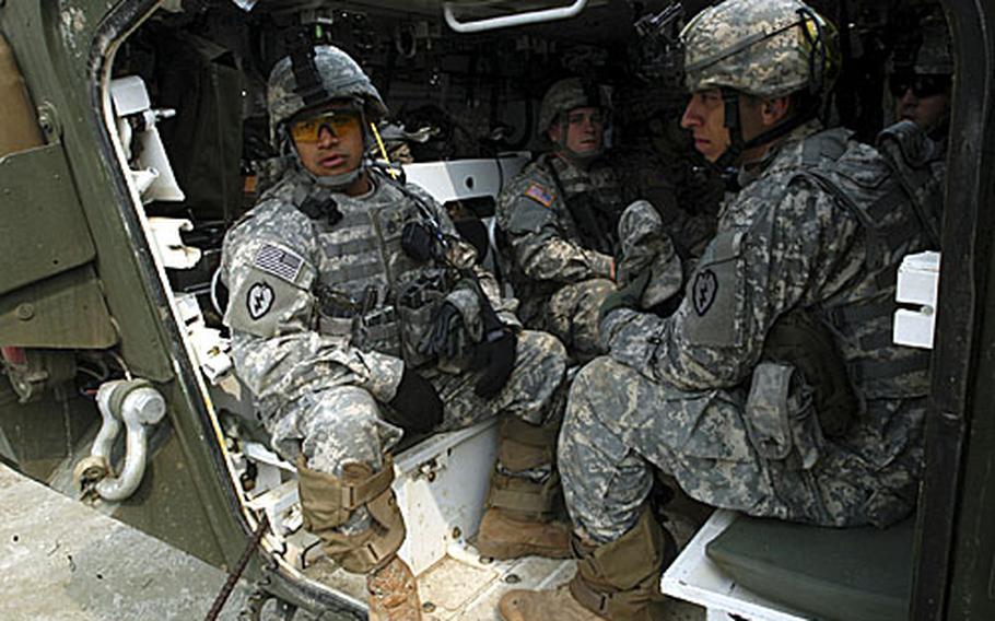 Soldiers sit in the back of their Stryker armored wheeled vehicle during a training exercise. The soldiers are in South Korea for the annual RSOI/Foal Eagle exercises conducted by U.S. and South Korean militaries.