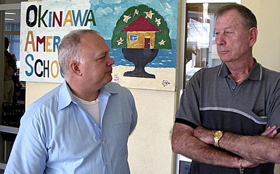 Stanley Taylor, left, the president of Sunny-Net Internet service provider, and Ernie Ernst, vice commander of the American Legion Post 28 on Okinawa, visit the Okinawa AmerAsian School in Ginowan, Okinawa on Wednesday with a donation they made to equip the school with modern computer technology.