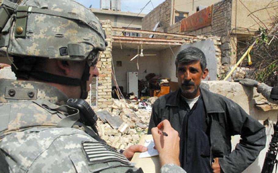 1st Lt. Jonathan Martin, 25, of Independence, Mo., interviews a man about a house that mysteriously exploded during the night in the Zafaraniya neighborhood of eastern Baghdad recently. Soldiers concluded that the small, unoccupied house was hit by a mortar.
