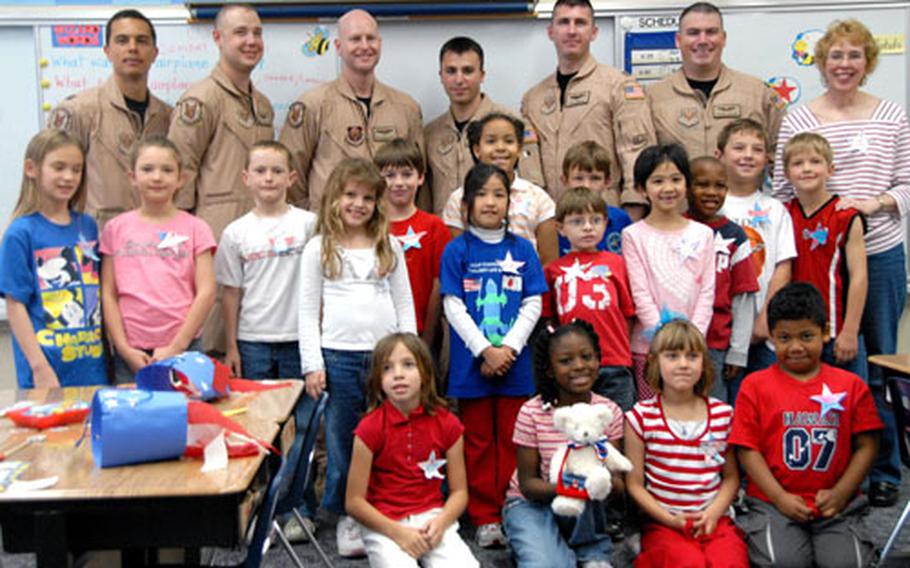 Diane LaMarr&#39;s second-grade class at E.C. Killin Elementary School on Camp Foster, Okinawa, poses for a picture Friday with the airmen they corresponded with in Iraq.
