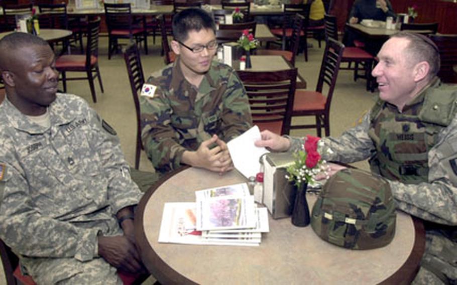 Lt. Col. Avi Weiss, right, talks with Cpl. Suk Man-eun, center, and Sgt. 1st Class Anderson Joseph at the Kilbourne Dining Facility on Camp Red Cloud, South Korea, on Thursday. Weiss, a rabbi, is preparing the upcoming Passover program while fulfilling his new role as the 1st Signal Brigade chaplain.