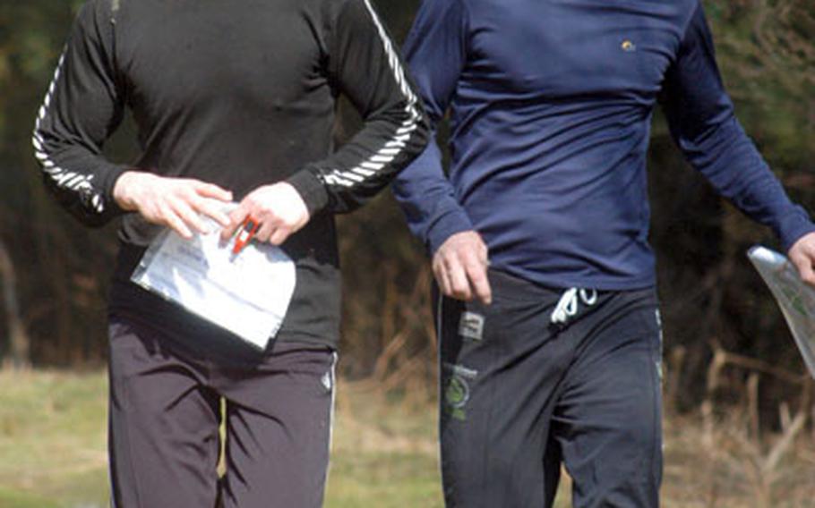 Steve Hill, left, and his father, Goff, raced to the finish line at an orienteering event last Saturday near Ipswich, but participants can walk, stroll or get to the finish line however they please. The sport, popular in Britain, involves navigating an outdoor course with a compass and map. The red device on Steve&#39;s finger is used to electronically record progress at the checkpoints.