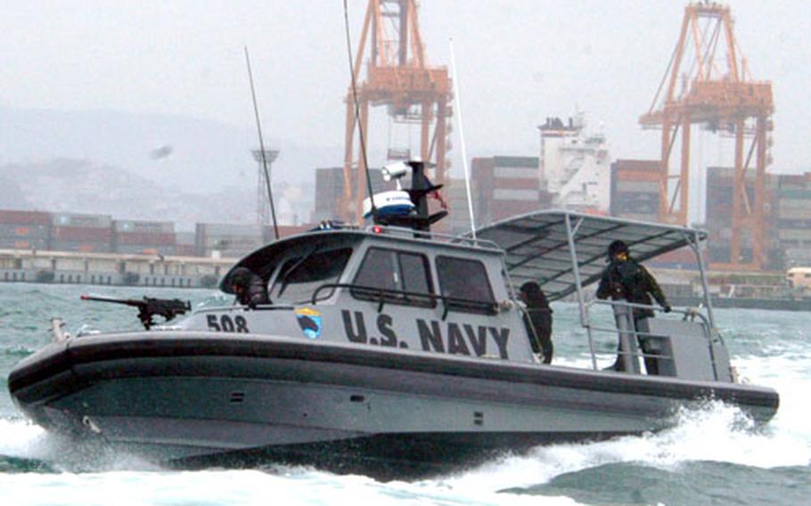 A Dauntless Patrol Craft from Inshore Boat Unit 13 makes a hard to starboard turn in Busan Harbor during training Tuesday. The boat intercepts threats to the harbor, defends friendly boats and conducts surveillance to provide waterborne portside security.