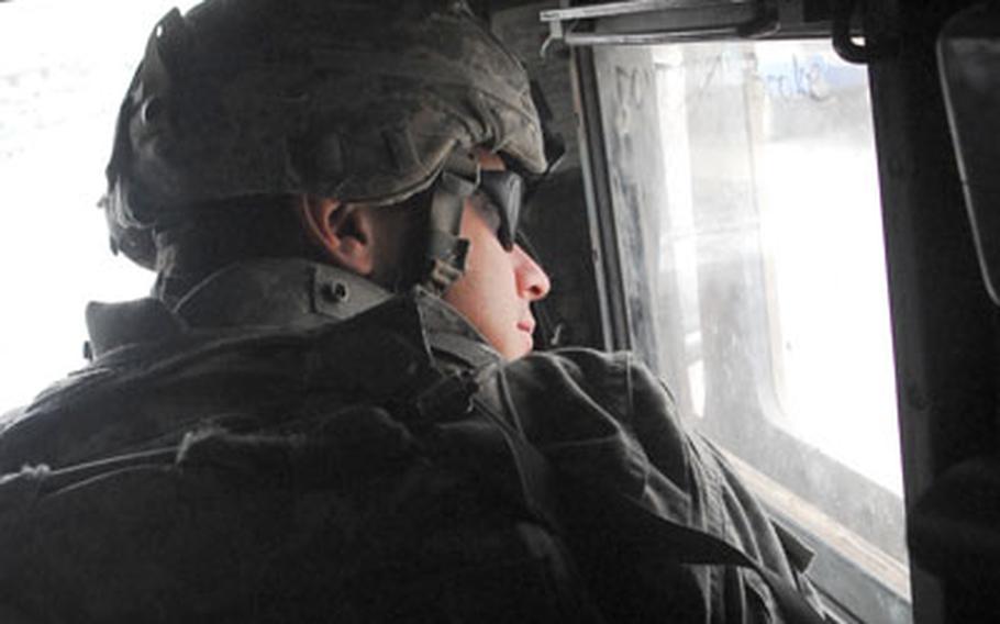 Staff Sgt. Daniel Newsome, 27, of Springfield, Mass., searches for a drive-by shooter from the vehicle commander&#39;s seat of a Humvee in east Baghdad on Wednesday.