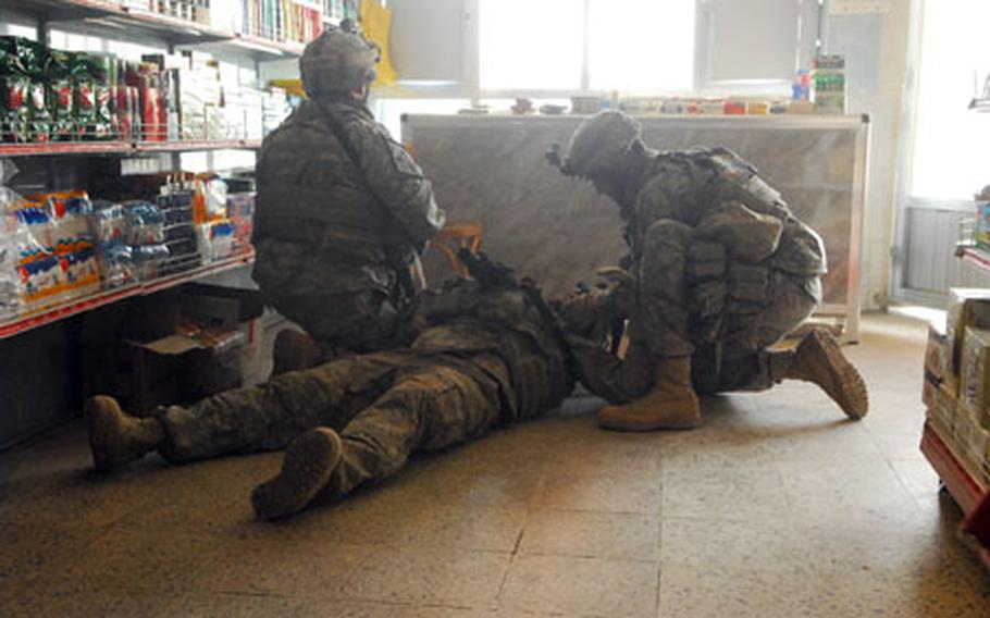 A soldier attached to the 2nd Brigade Combat Team, 2nd Infantry Division, lies on the floor of an East Baghdad market recently after being sprayed by glass from a bullet that shattered the shop&#39;s window. The soldier, who at first thought he had been struck, was uninjured. The bullet was either fired by a drive-by gunman or a sniper while the soldiers were on patrol.