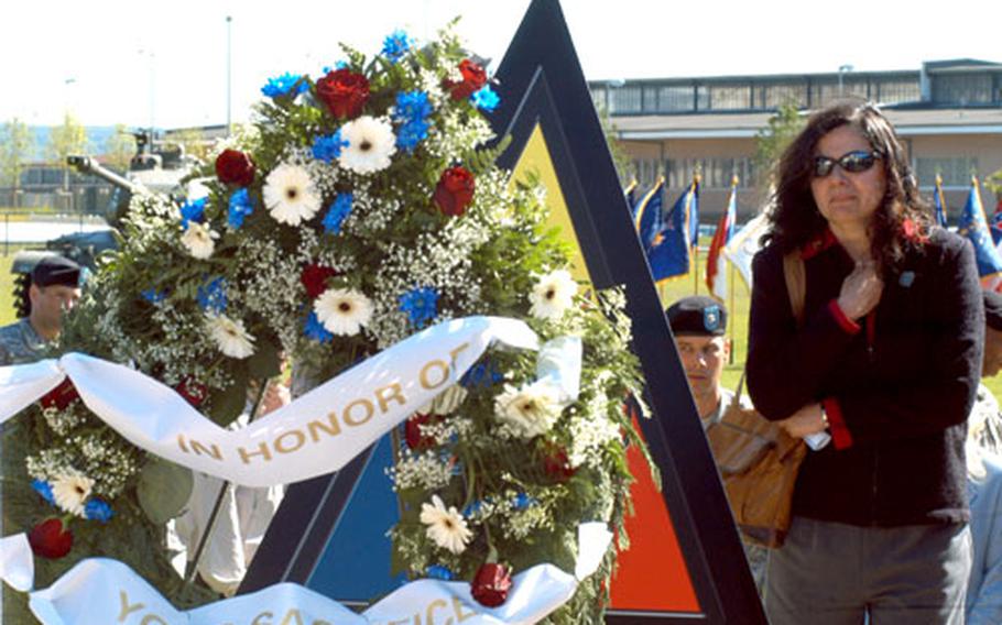 Lynda MacFarland, wife of Col. Sean B. MacFarland, commander of the 1st Brigade, 1st Armored Division, pauses in front of a replica of a new memorial dedicated Wednesday to the memory of Germany-based 1st Armored and 1st Infantry Division soldiers killed in Iraq between 2006 and 2008.