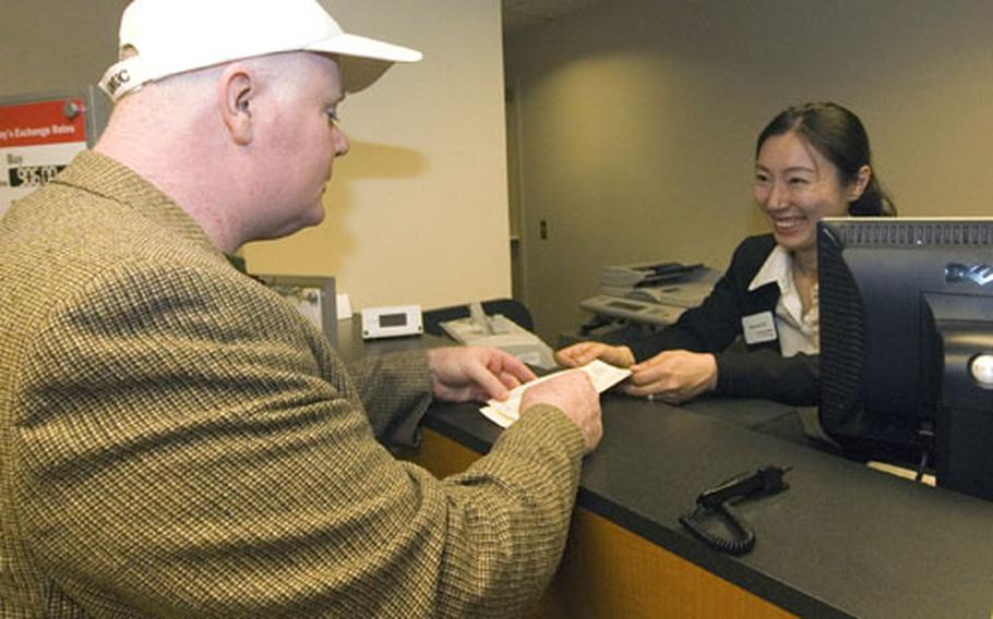 Devilin Parrish wass the first customer of the new K-16 Air Base Community Bank following a ribbon-cutting ceremony last week.