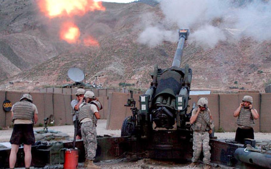 Soldiers of the 10th Mountain Division&#39;s Battery B, 4th Battalion, 25th Field Artillery Regiment, fire their M-198 155mm medium howitzer at anti-coalition positions in northeastern Afghanistan. The artillery piece can send a shell 18 miles down range.