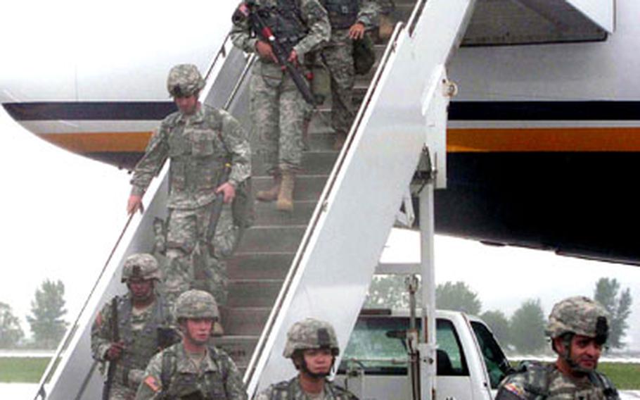 At Suwon Air Base in South Korea on Wednesday, soldiers of the 1st Battalion, 7th Air Defense Artillery, come down the ramp after flying in from Fort Bliss, Texas.