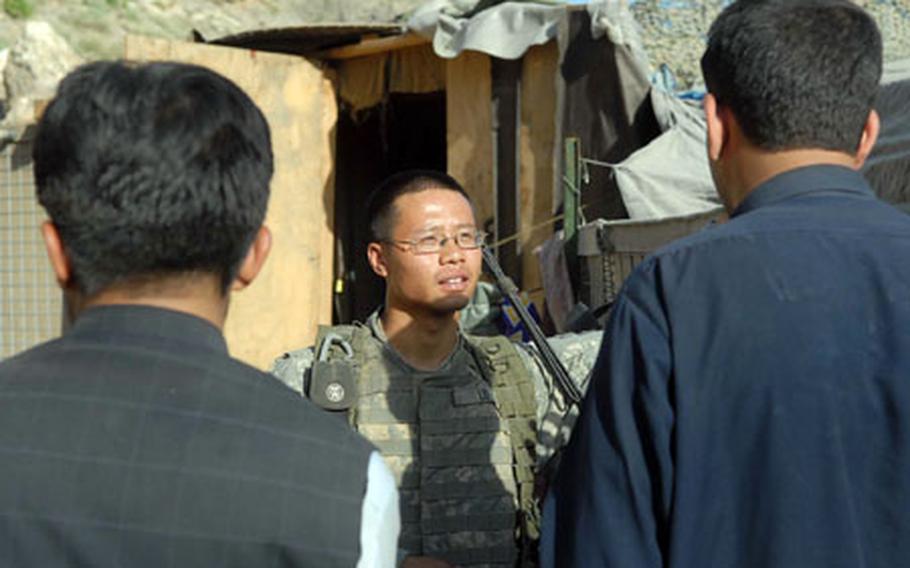 1st Lt. Tim Lo, platoon leader with 3rd Platoon, Company C, 1st Battalion, 32nd Infantry Regiment, 10th Mountain Division, talks to contractors at the gate of Fire Base Florida, where the platoon is based.