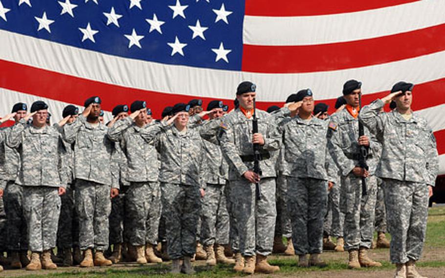 Soldiers of the 22nd Signal Brigade salute during the playing of the national anthem at the ceremony inactivating the 22nd Signal Brigade and the 440th and 32nd Signal Battalions.