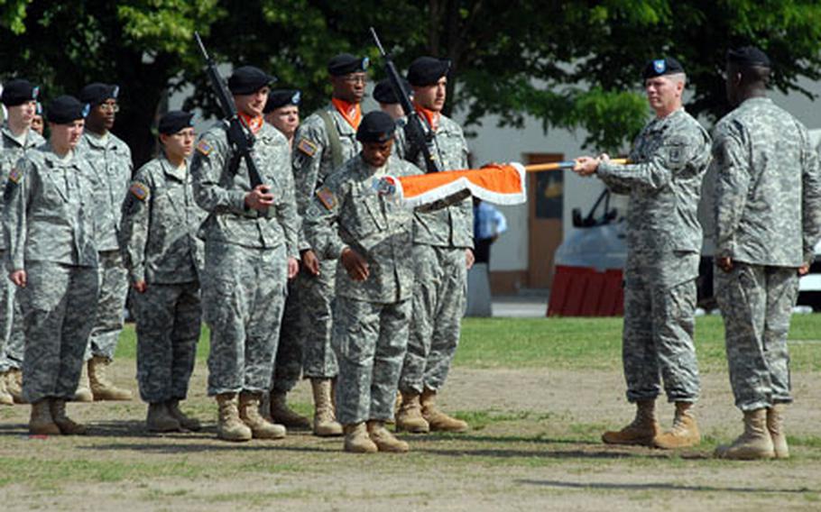 Lt. Col. Derek Orndorff, right, commander of the 440th Signal Battalion, holds the guidon as Master Sgt. Ricardo Weems prepares to case the colors at the inactivation ceremony for the 22nd Signal Brigade and the 440th and 32nd Signal Battalions in Darmstadt, Germany, on Tuesday.