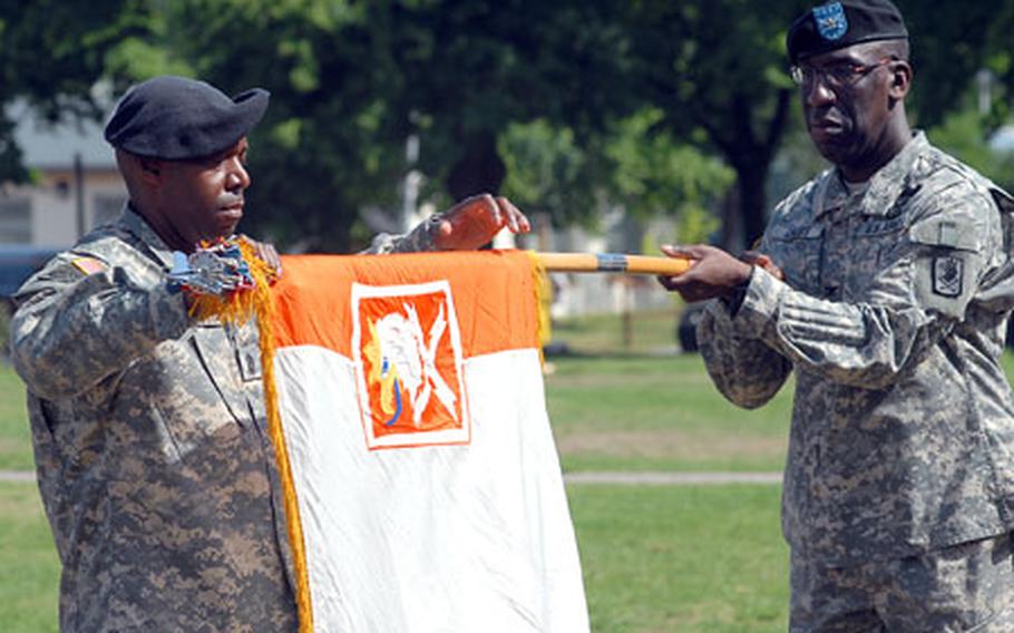 Col. Frederick Cross, right, and Command Sgt. Maj. John Graves roll up the colors of the 22nd Signal Brigade during the unit&#39;s inactivation ceremony.