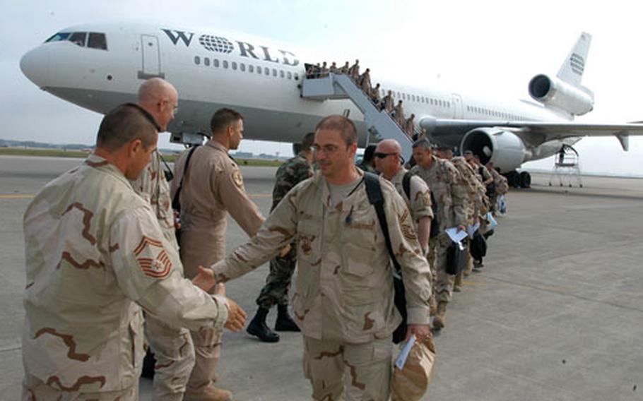 Misawa Air Base, Japan, airmen deployed to Iraq since January pour off the plane arriving home Saturday morning. About 300 airmen were welcomed by an exuberant crowd of families, friends and co-workers outside Hangar 949.