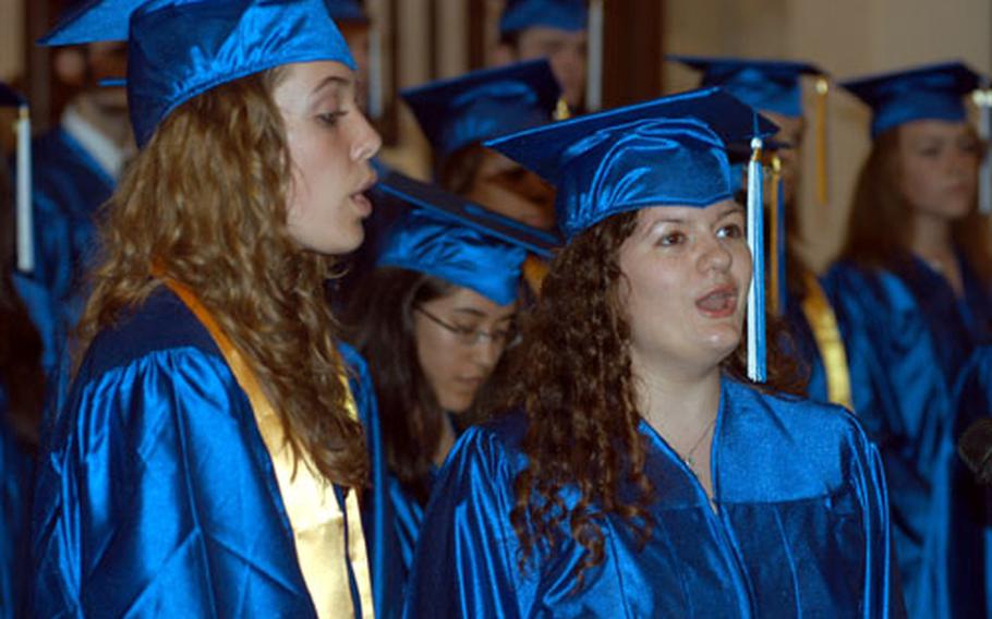 Janet Parker, left, and Ramona Villareal, sing the national anthem during the commencement ceremony for the London Central High School class of 2007.