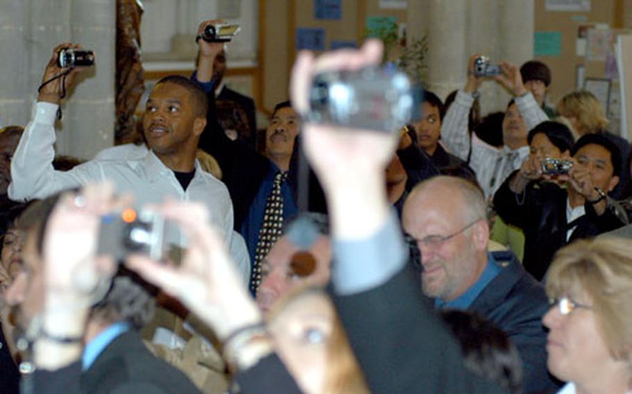 Friends and relatives of the London Central High School class of 2007 capture the ceremony on still and video cameras.