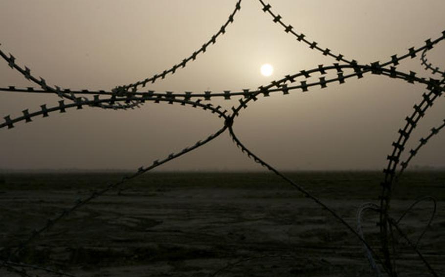 The sun sets outside the wire of a remote outpost in Iraq’s Diyala province, where fighting between U.S. forces and insurgents has flared since President Bush ordered more reinforcements to the country in January. The surge in forces, which was meant to bolster security in the Iraqi capital of Baghdad, sent insurgents flooding into Diyala, where daily clashes with U.S. troops are now routine.