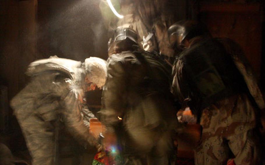 U.S. soldiers with the 1-12th Combined Arms Battalion and Iraqi army troops search a house during a midnight raid in the village of Nahir Shallub, in Iraq’s Diyala province.