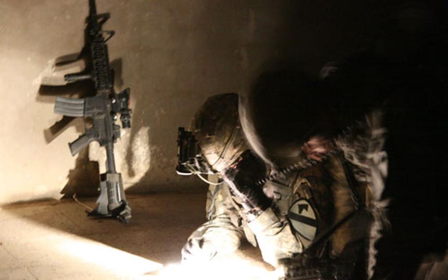 Capt. Alex Rivera, 39, of Columbus, Ga., confirms his location on a map during a raid on the village of Nahir Shallub, in Iraq’s Diyala province.