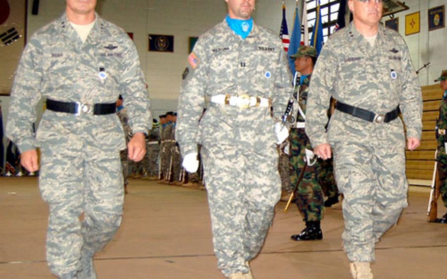 United Nations Command Honor Guard Company Commander Capt. Brett Wiersma, center, escorts incoming U.S. Forces Korea Deputy Chief of Staff Maj. Gen. Johnny Weida, left, and outgoing Maj. Gen. Stephen Sargeant as they inspect the UNC Honor Guard formation during a ceremony Thursday on Yongsan Garrison, South Korea.