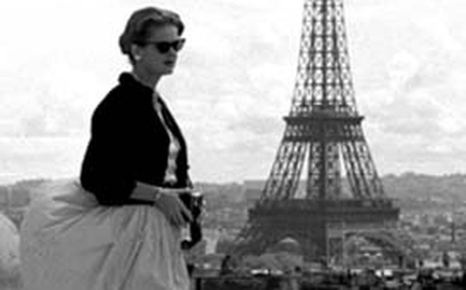 A gust of wind atop the Arc de Triomphe brings about a Marilyn Monroe moment ...